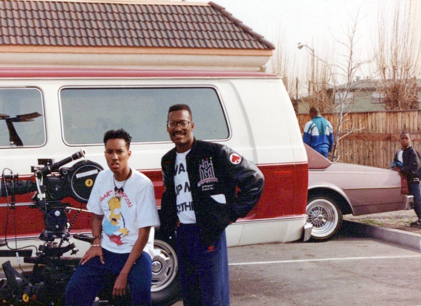 Filmmakers standing by a red and white van
