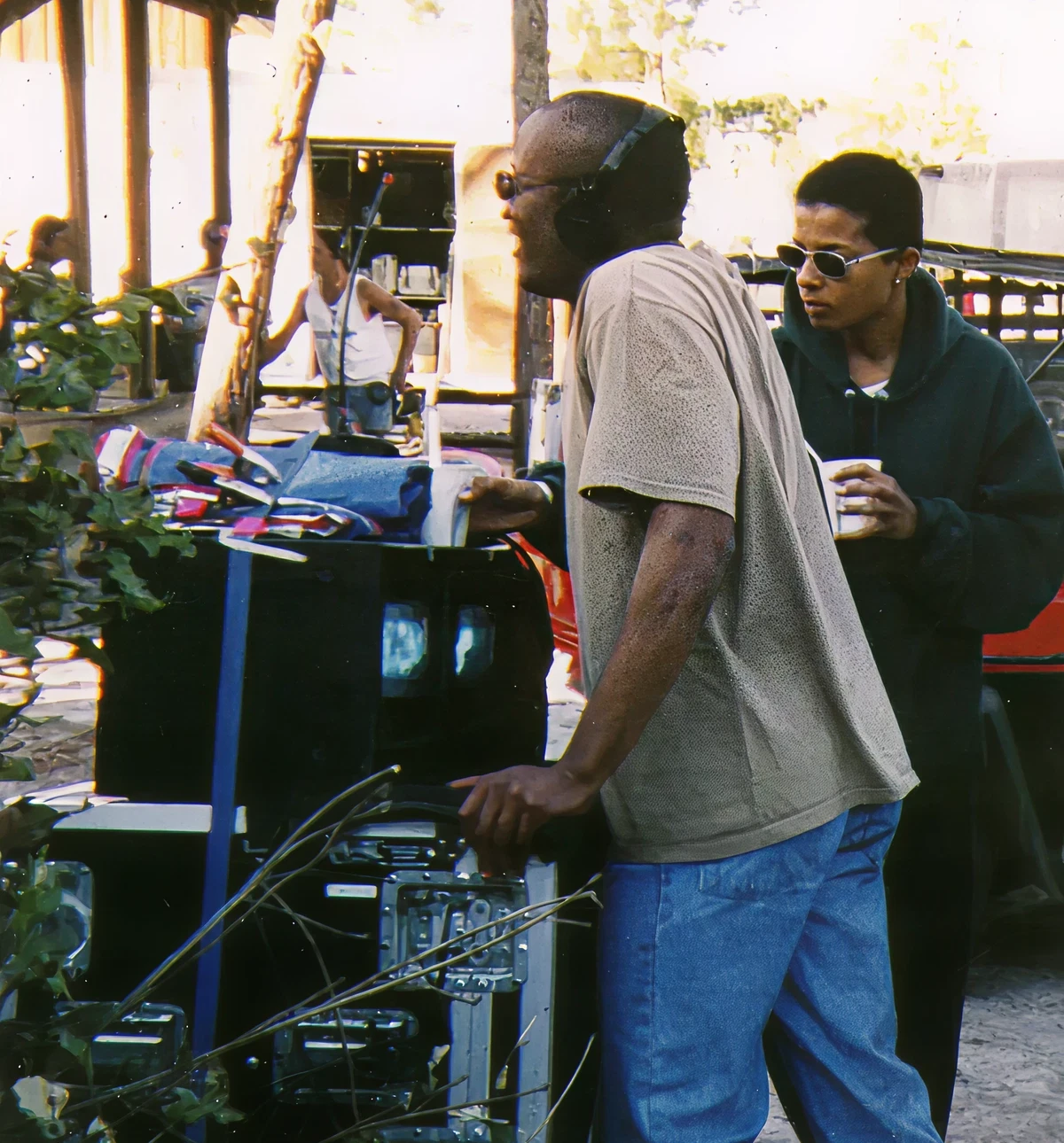 Two people managing video equipment on set